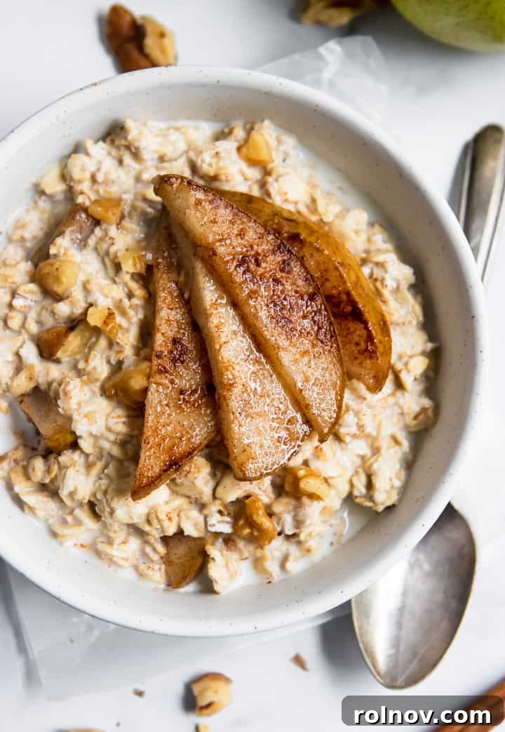 Fragrant Spiced Pear and Walnut Overnight Oats 2 Spiced Pear Oatmeal in bowl. A warm and cozy breakfast recipe with baked pears, cinnamon, walnuts, and maple.