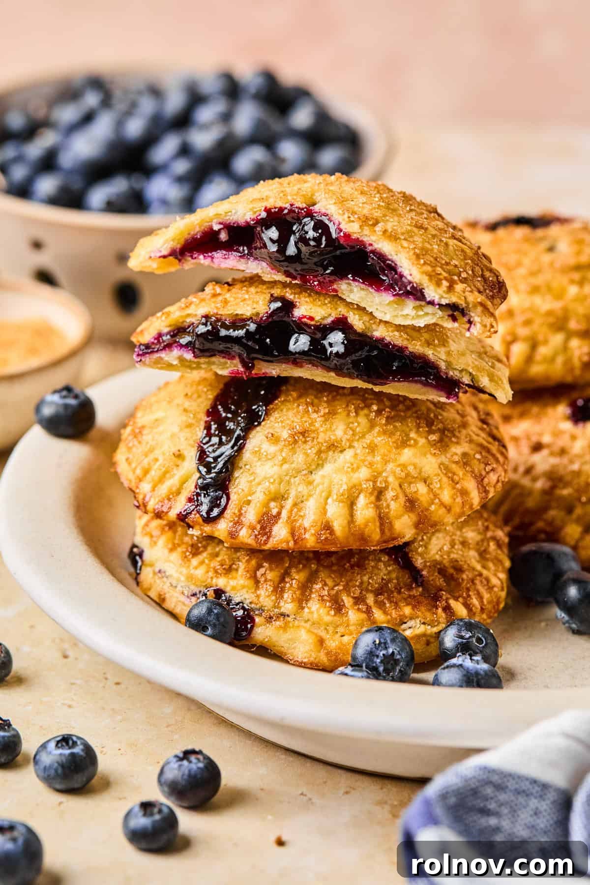 Crispy Air-Fried Blueberry Turnovers 2 A beautifully arranged plate of stacked air fryer hand pies, revealing their luscious blueberry filling.