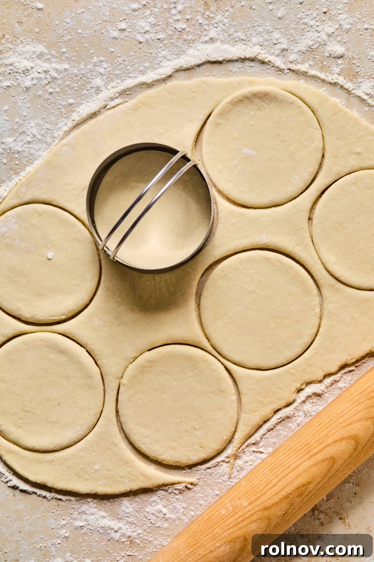 Crispy Air-Fried Blueberry Turnovers 12 Biscuit cutters pressing into the rolled-out dough to create perfect circular pie shapes.