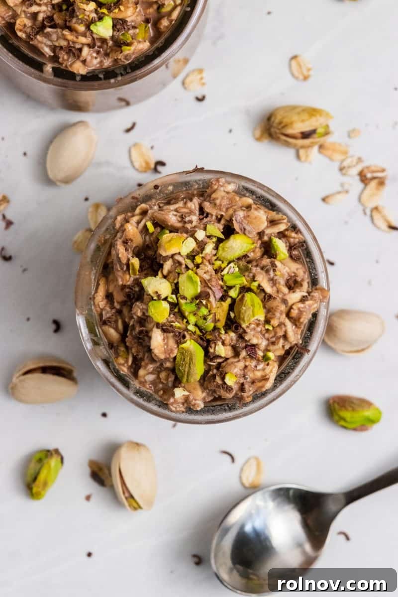 Decadent Chocolate Pistachio Overnight Oats 3 An inviting overhead shot of a serving of Chocolate Pistachio Overnight Oats in a bowl, with a spoon resting in it, highlighting the creamy texture and pistachio garnish.