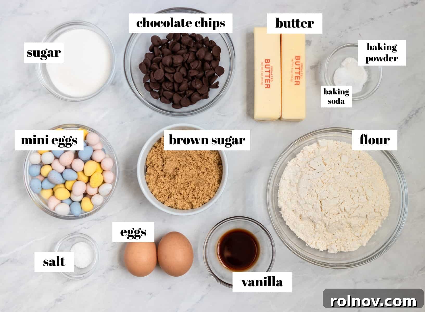 Easter Mini Egg Cheesecake Bars 3 Flour, eggs, chocolate chips and other ingredients labeled on counter.