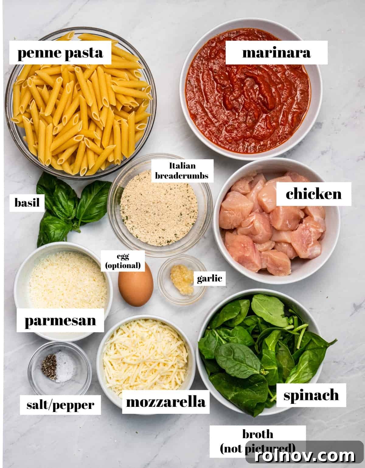 Golden Baked Chicken Parm 3 Pasta, marinara, cheese and other ingredients labeled on counter.