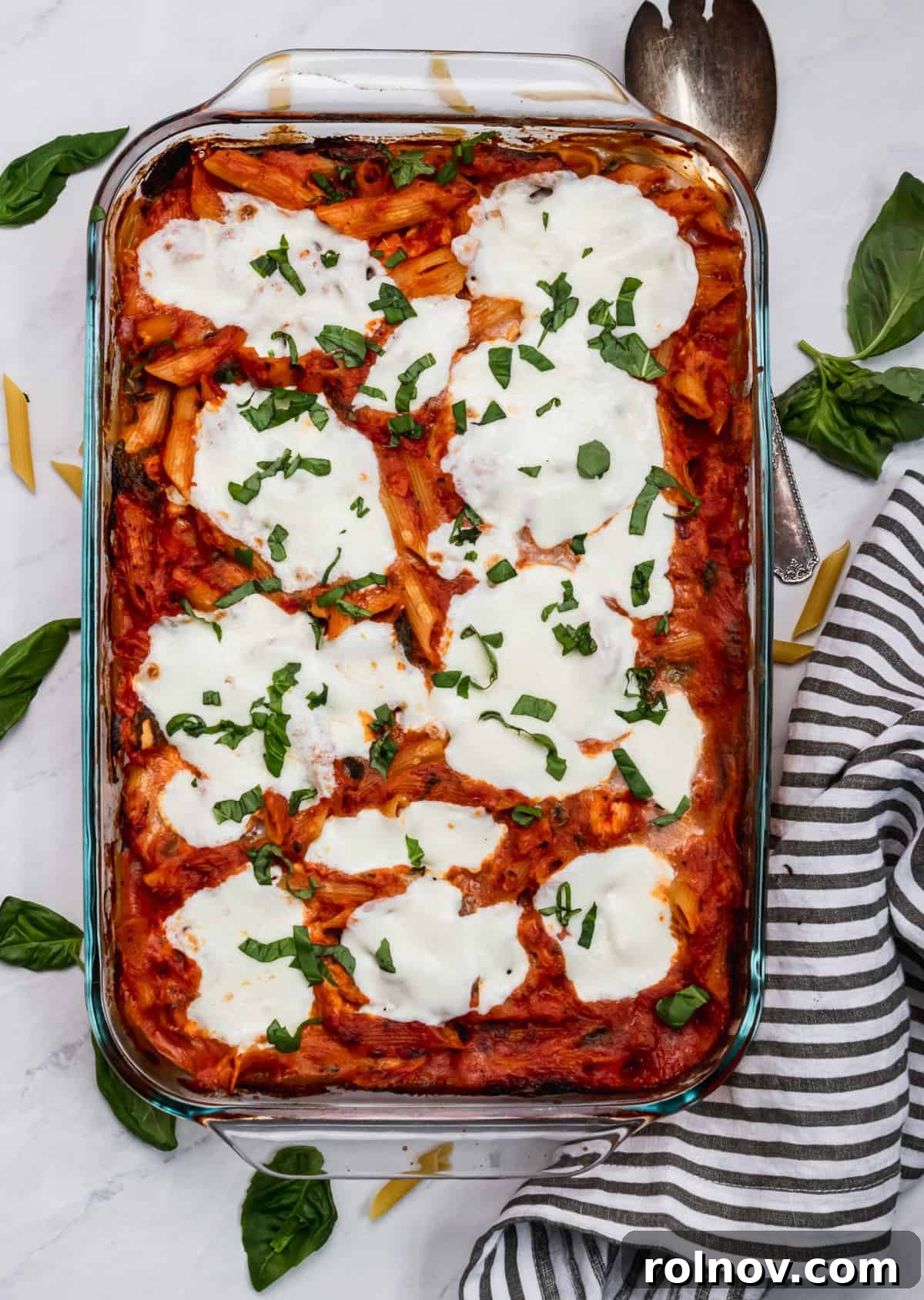 Golden Baked Chicken Parm 6 Chicken Parmesan pasta bake with fresh mozzarella melted on top and parsley.