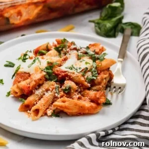 Chicken parmesan casserole on plate with fresh parsley.