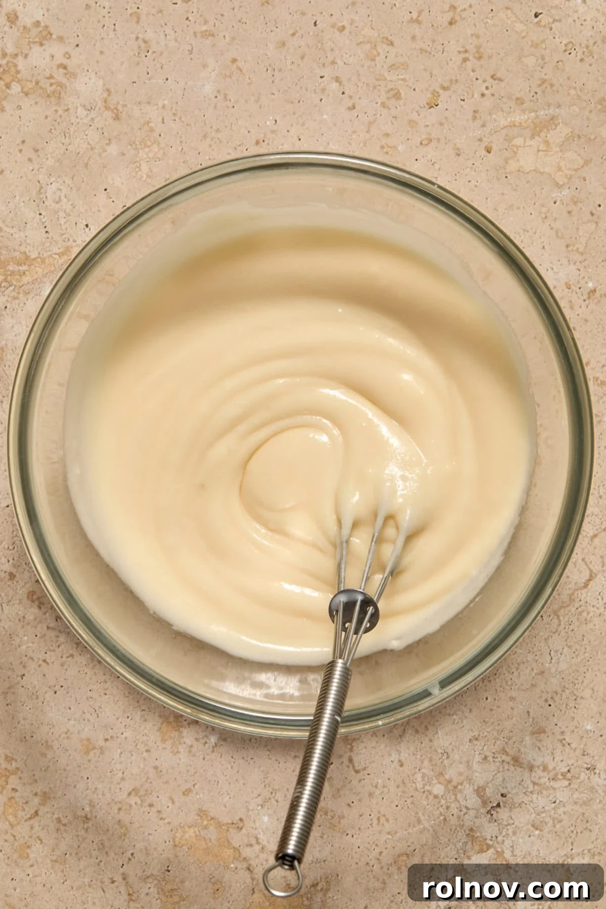Flaky Cinnamon Swirls 11 Whisked maple icing in bowl.