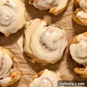 Flaky Cinnamon Swirls 14 Maple icing topped puff pastry cinnamon rolls on parchment.