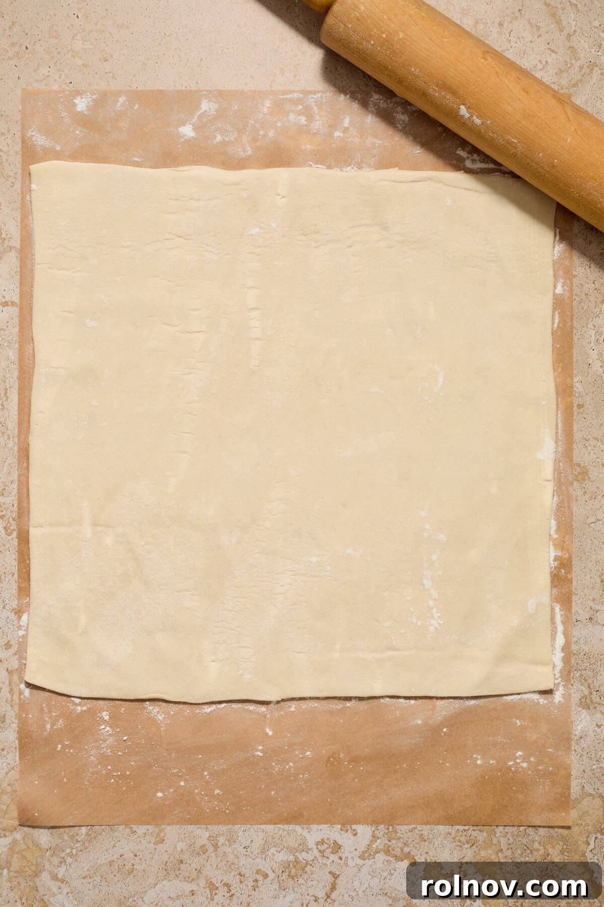 Flaky Cinnamon Swirls 4 Rolled puff pastry on lightly flour dusted parchment paper.