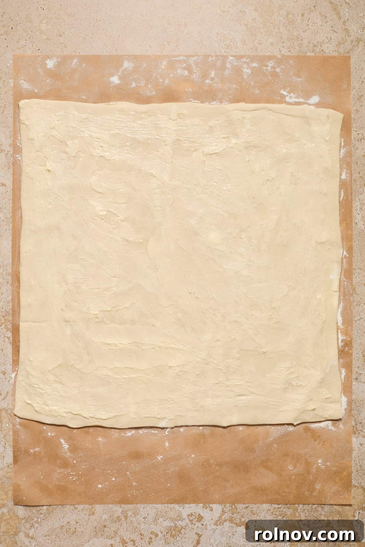 Flaky Cinnamon Swirls 5 Butter spread over puff pastry sheet.
