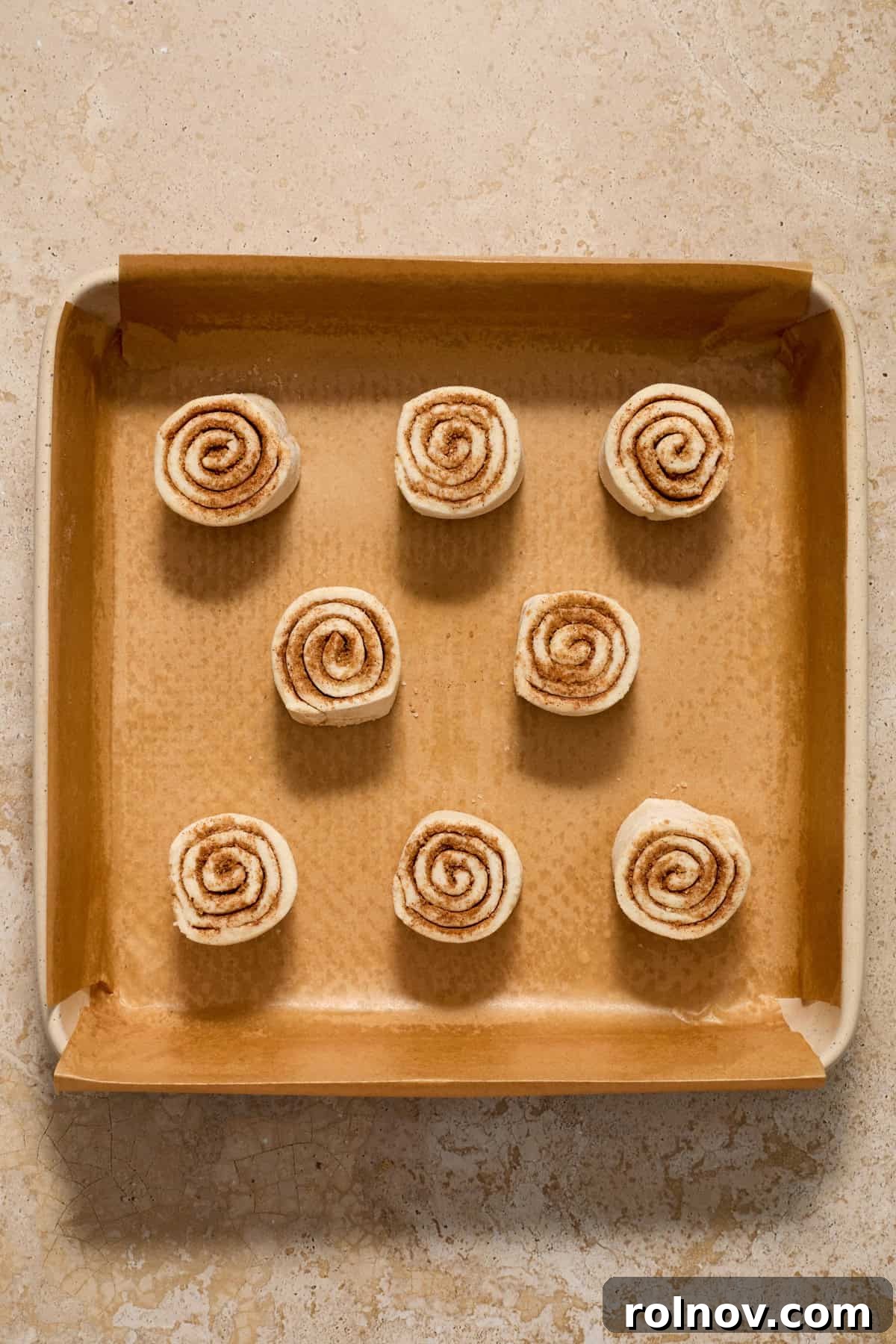 Flaky Cinnamon Swirls 9 Baking pan with prepped cinnamon rolls before baking.