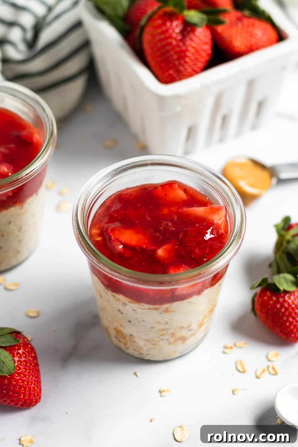 A jar of Peanut Butter and Jelly Overnight Oats ready to eat, featuring a perfect blend of creamy peanut butter and fresh berry layers.