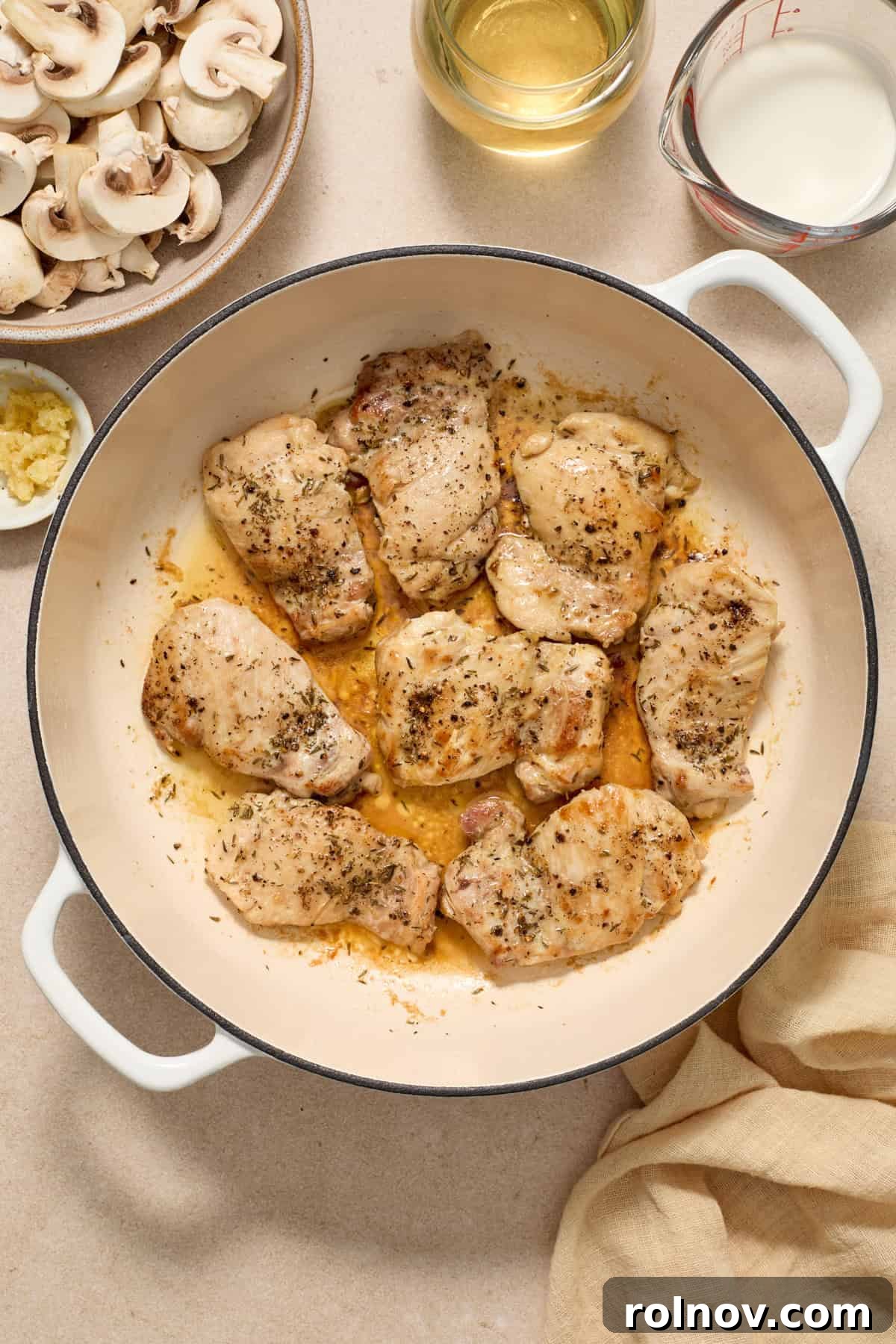 Golden Chicken Thighs in Velvety Mushroom Sauce 5 Seared boneless skinless chicken thighs in pan.