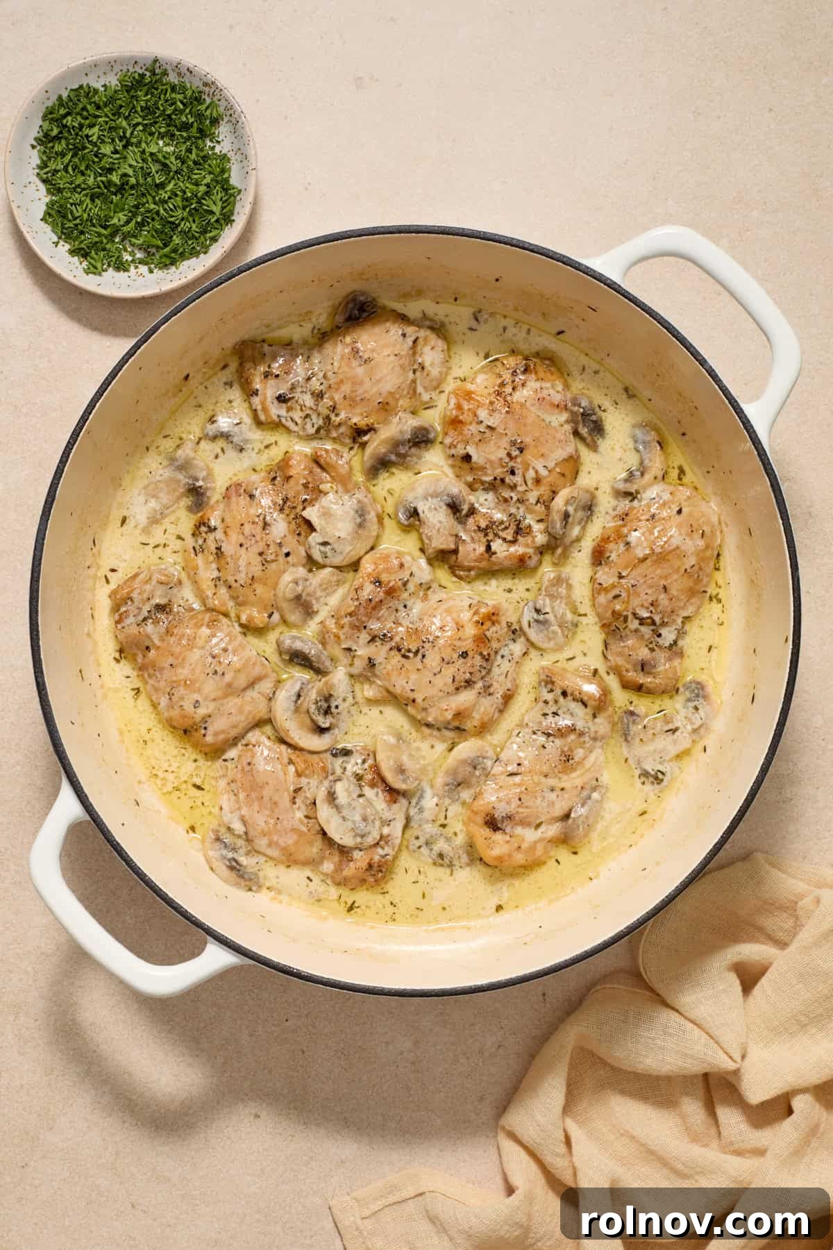 Golden Chicken Thighs in Velvety Mushroom Sauce 8 Cream added to chicken thighs and mushrooms in pan.