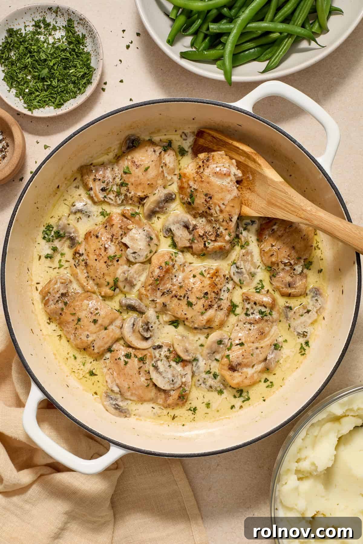 Golden Chicken Thighs in Velvety Mushroom Sauce 10 Overhead view of chicken and mushrooms in skillet.