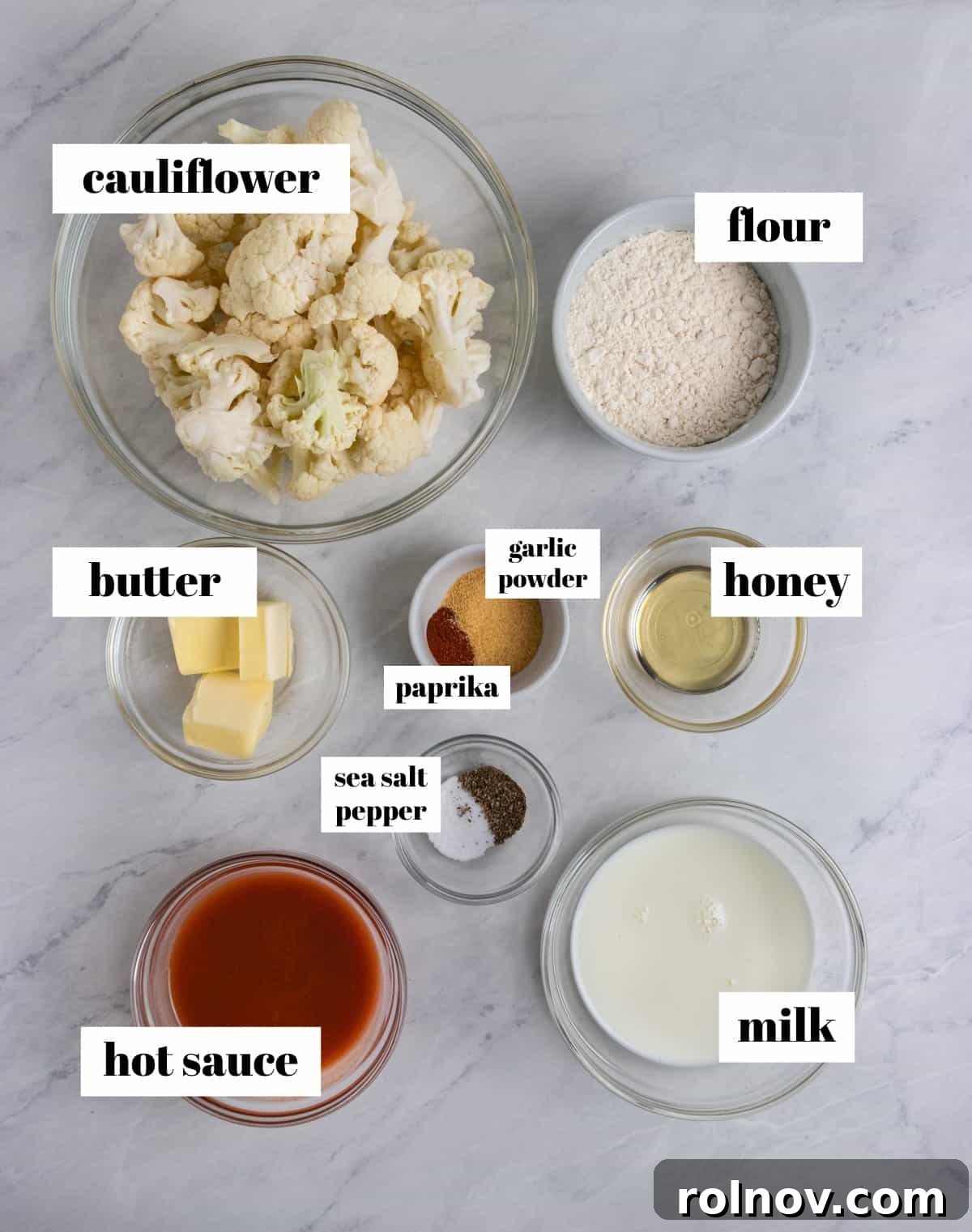 Zesty Air-Fried Buffalo Cauliflower 3 Hot sauce, butter, milk, flour and other ingredients labeled on counter.