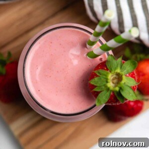 Strawberry Nut Bliss Smoothie 6 Overhead view of strawberry peanut butter smoothie with green straws.