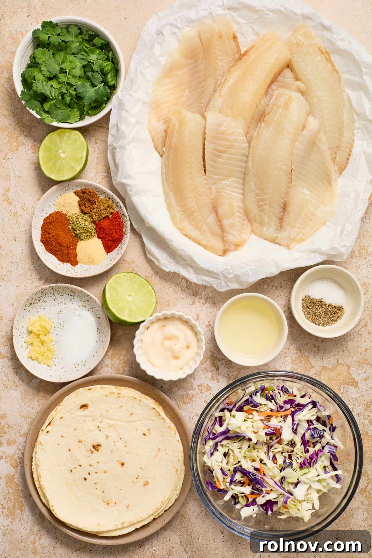 Crispy Air Fried Fish Tacos and Zesty Cilantro Lime Slaw 4 Fish, tortillas, slaw, spices and other ingredients labeled on a counter.
