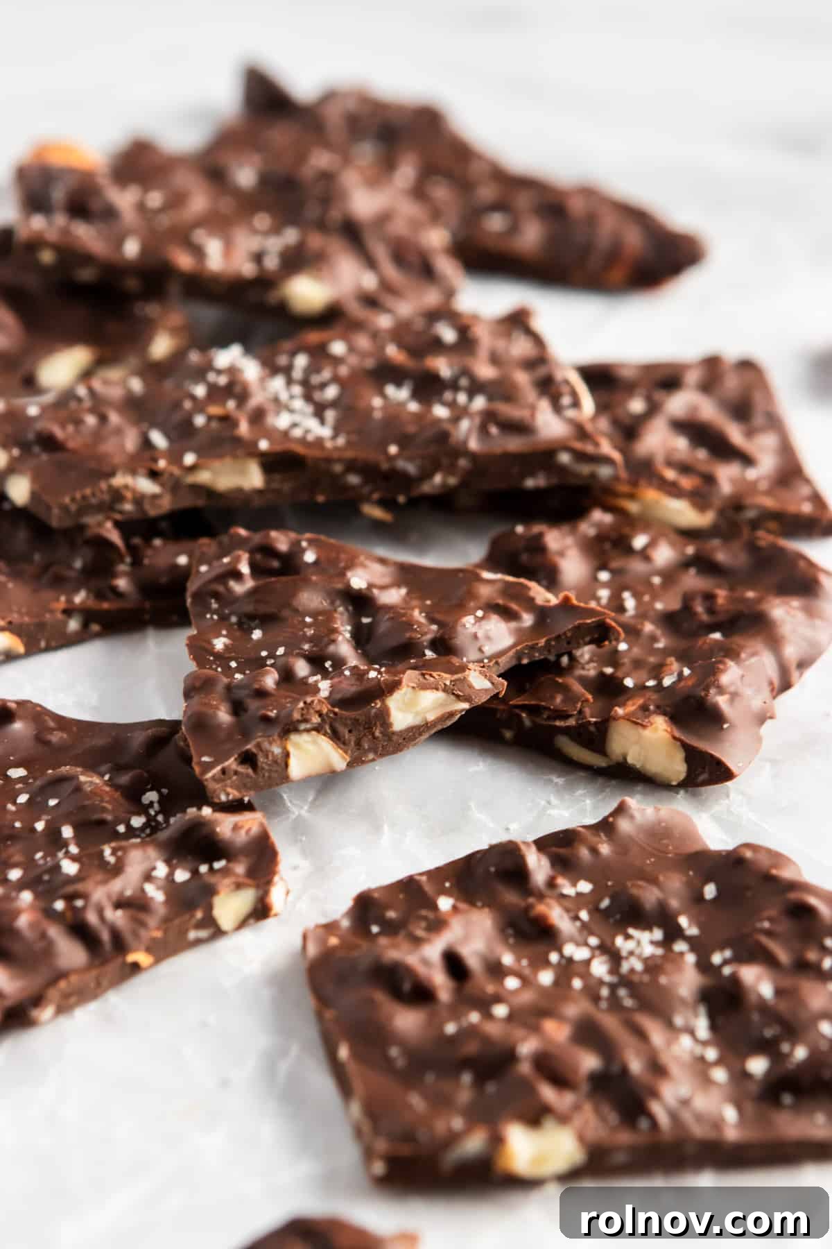 Sweet and Salty Dark Chocolate Almond Bark Thins 7 Close up of chocolate almond bark thins with sea salt, showing the perfectly irregular pieces and crunchy texture.