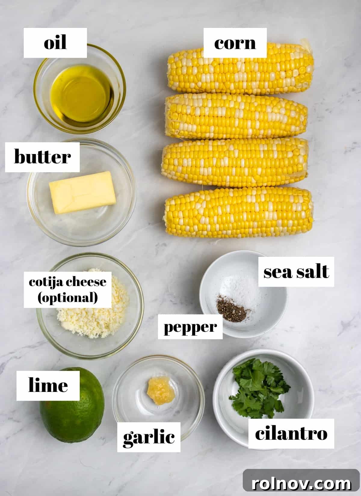 Air Fried Corn on the Cob with Zesty Cilantro Lime Butter Glaze 3 Corn, butter, cilantro, oil, limes, and other fresh ingredients labeled on a kitchen counter, ready for preparation.