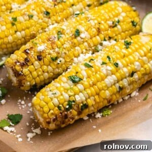 Cilantro lime air fryer corn on the cob sitting on brown parchment.
