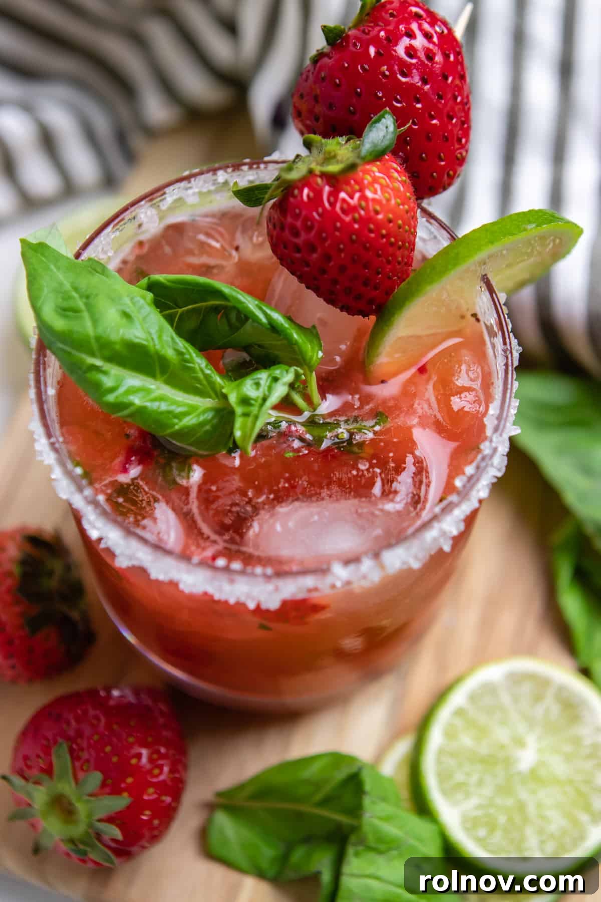 Garden Fresh Strawberry Basil Margarita 2 Strawberry basil margarita cocktail with lime and berry garnish.