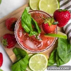 Garden Fresh Strawberry Basil Margarita 9 Overhead view of strawberry basil margarita with fresh lime and berries.