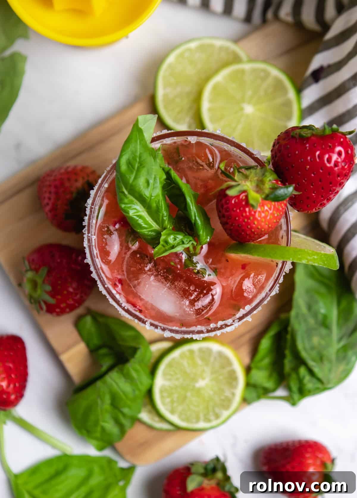 Garden Fresh Strawberry Basil Margarita 7 Overhead view of glass with strawberry margarita with fresh basil leaves.