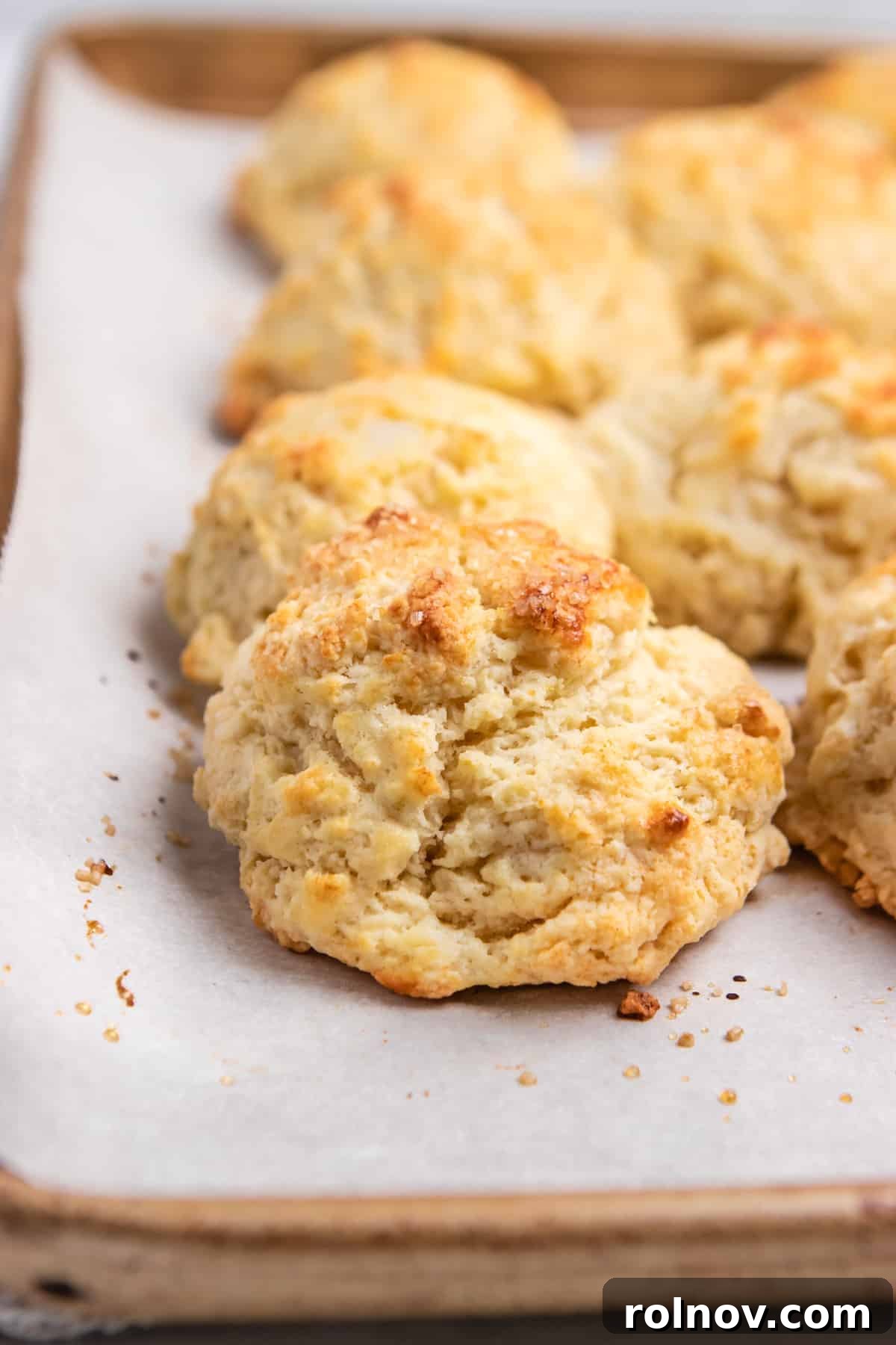 Sun-Kissed Peach Strawberry Shortcake 13 Buttermilk drop biscuits baked on parchment on sheet pan.
