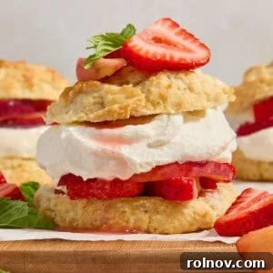 Layered biscuit, strawberries, peaches and whipped cream topped with fresh mint and berries.