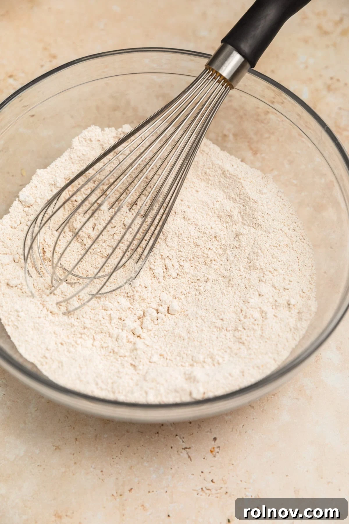 Spiced Apple Oat Pancakes 8 A bowl of oat flour with a whisk in it, ready for wet ingredients.