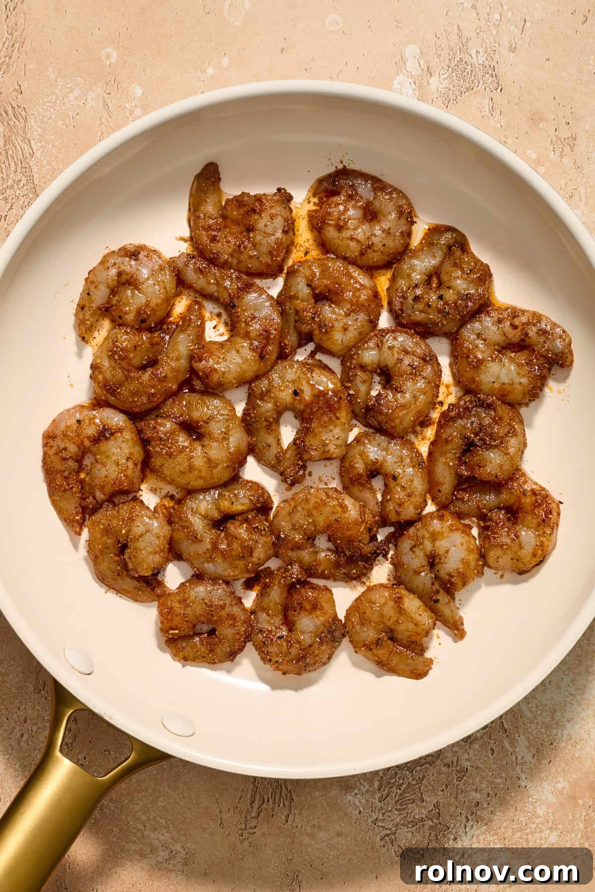 Tropical Shrimp Tacos with Mango Salsa 11 Marinated raw shrimp laid out in a skillet, just before cooking, ready to be pan-fried.
