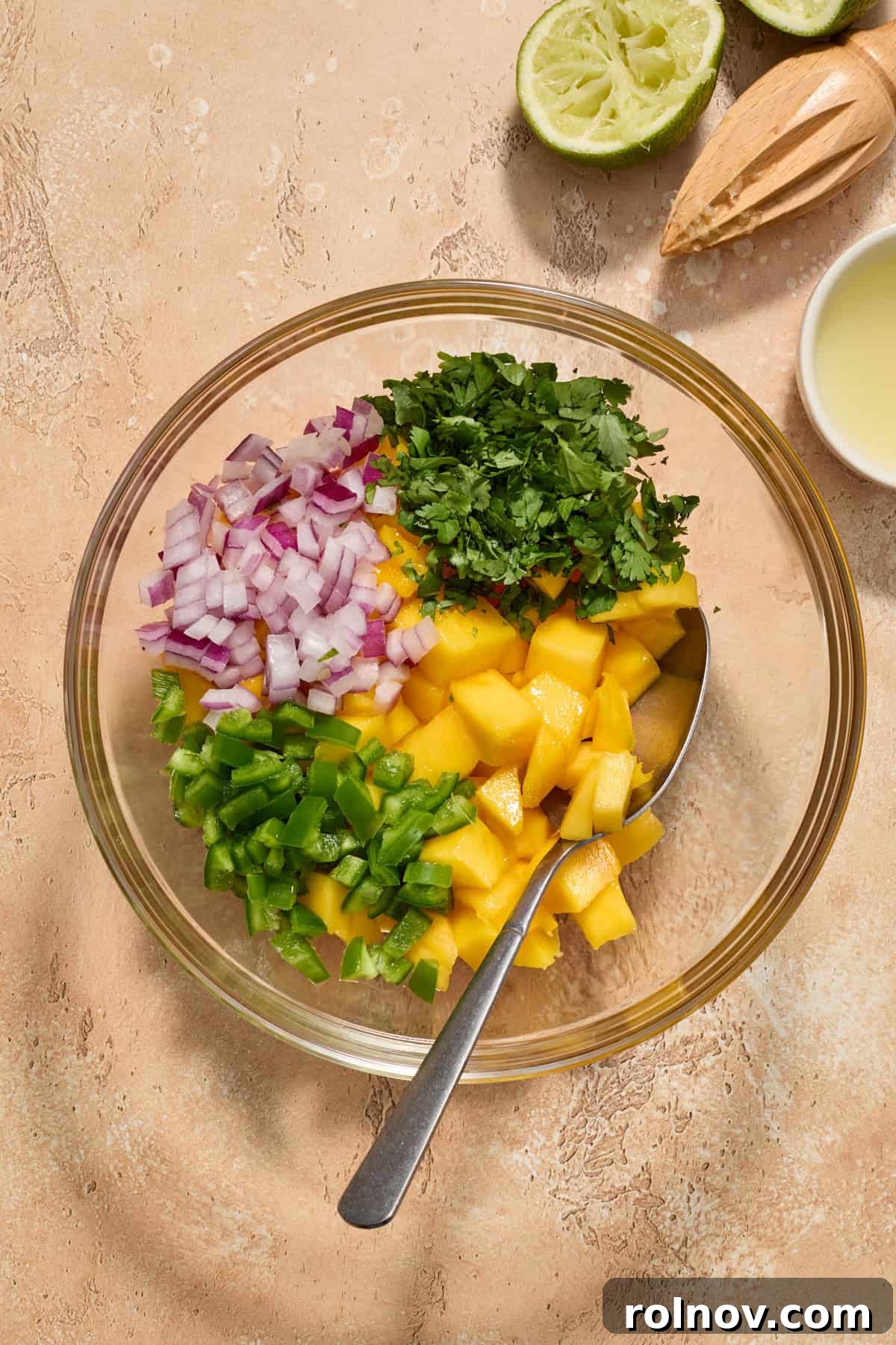 Tropical Shrimp Tacos with Mango Salsa 8 All the vibrant mango salsa ingredients gathered in a glass bowl, pre-mixing, showing their freshness.