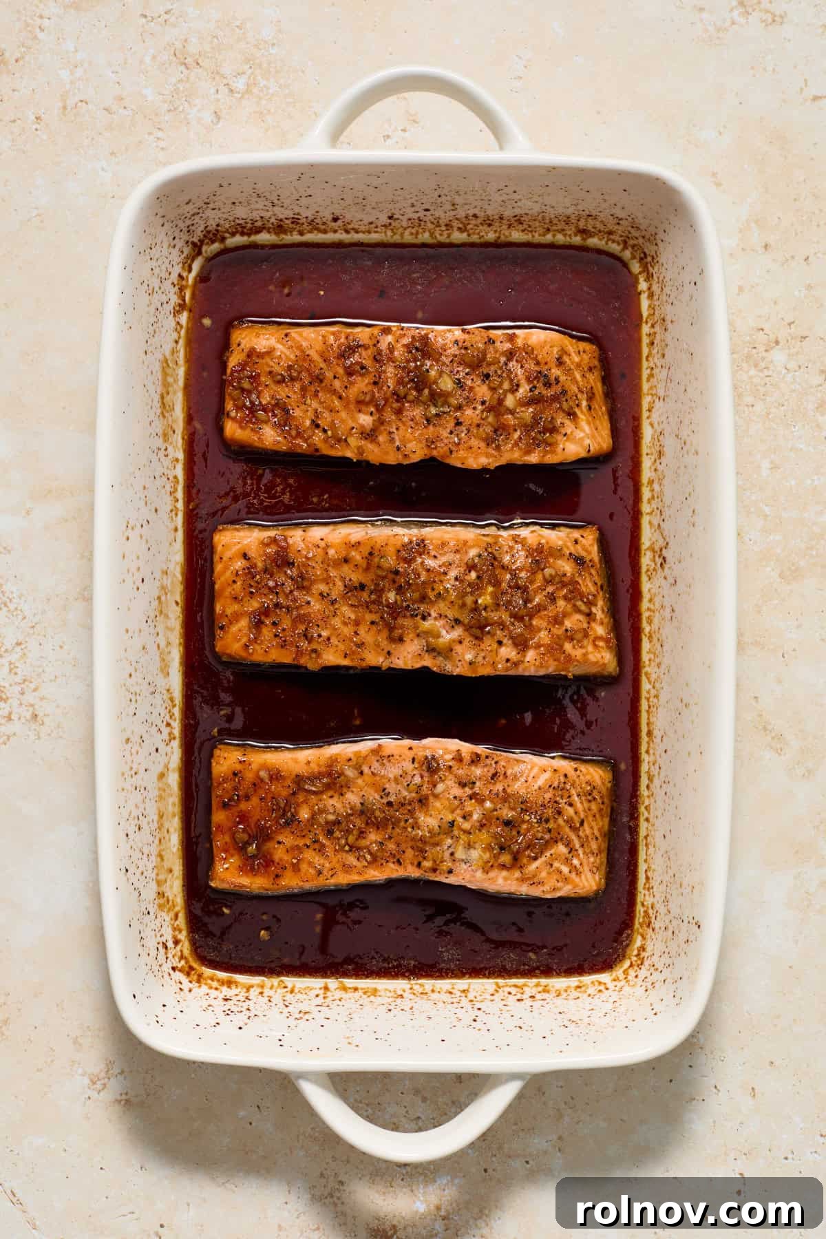 Baked citrus glazed salmon in baking pan.