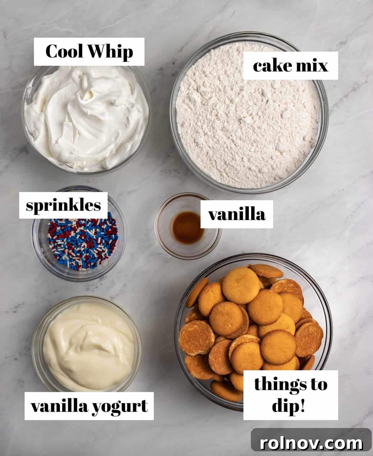 Celebration Funfetti Dip 4 Cool whip, sprinkles, vanilla and cake mix labeled on counter.