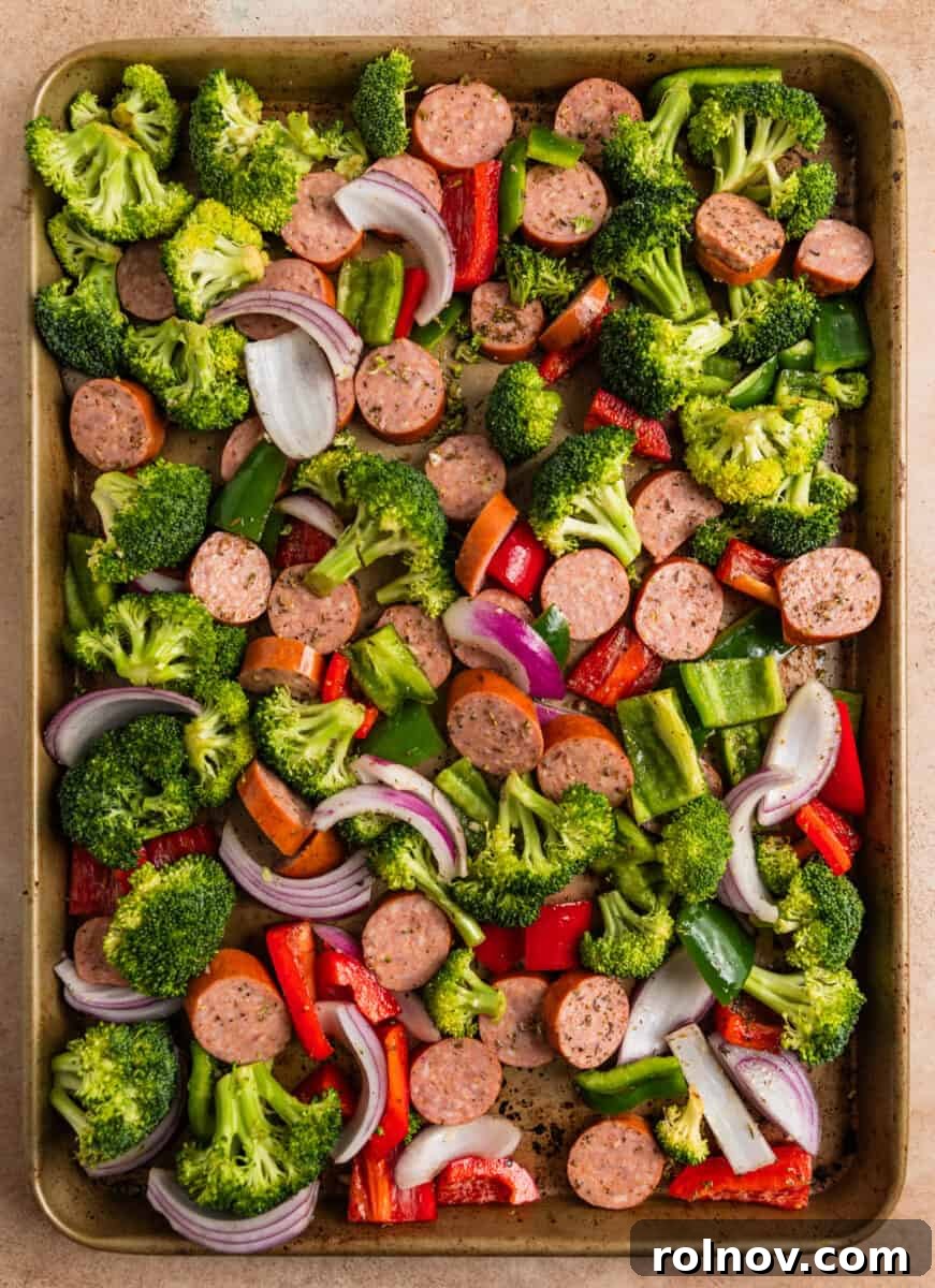 Roasted Sausage & Veggie Sheet Pan Supper 5 Sausages and veggies tossed in olive oil and seasoning on baking sheet.