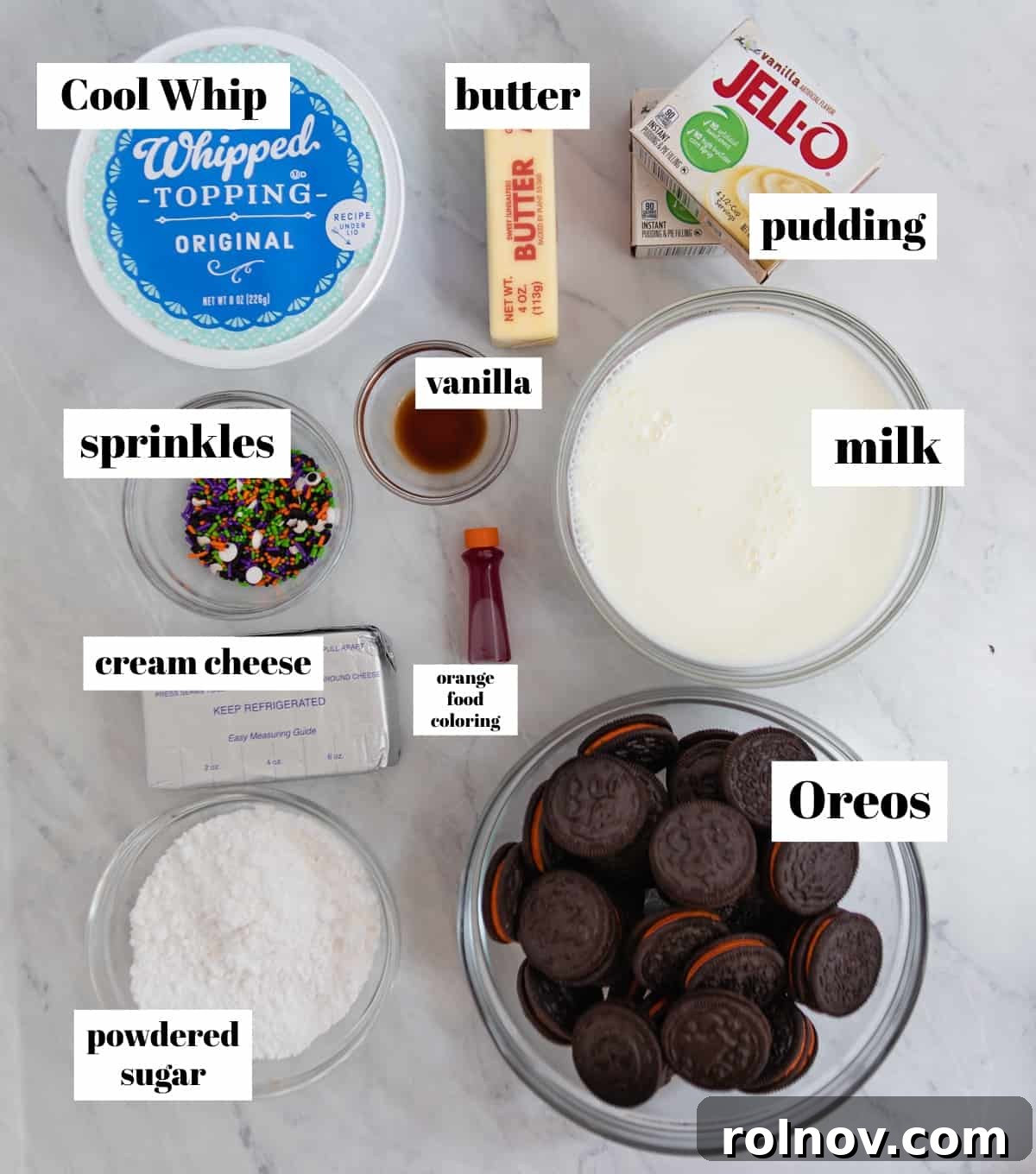 Halloween Oreo Graveyard Cake 3 Whipped cream, cream cheese, oreos, pudding and other ingredients labeled on counter.