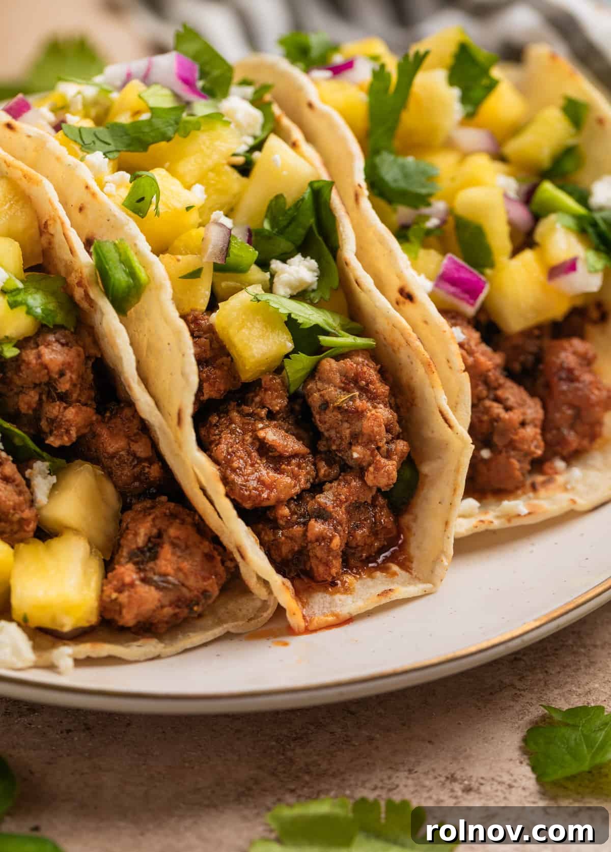 Zesty Pork Tacos with Fresh Pineapple Salsa 3 Tacos with ground pork, pineapple salsa and cojita cheese.