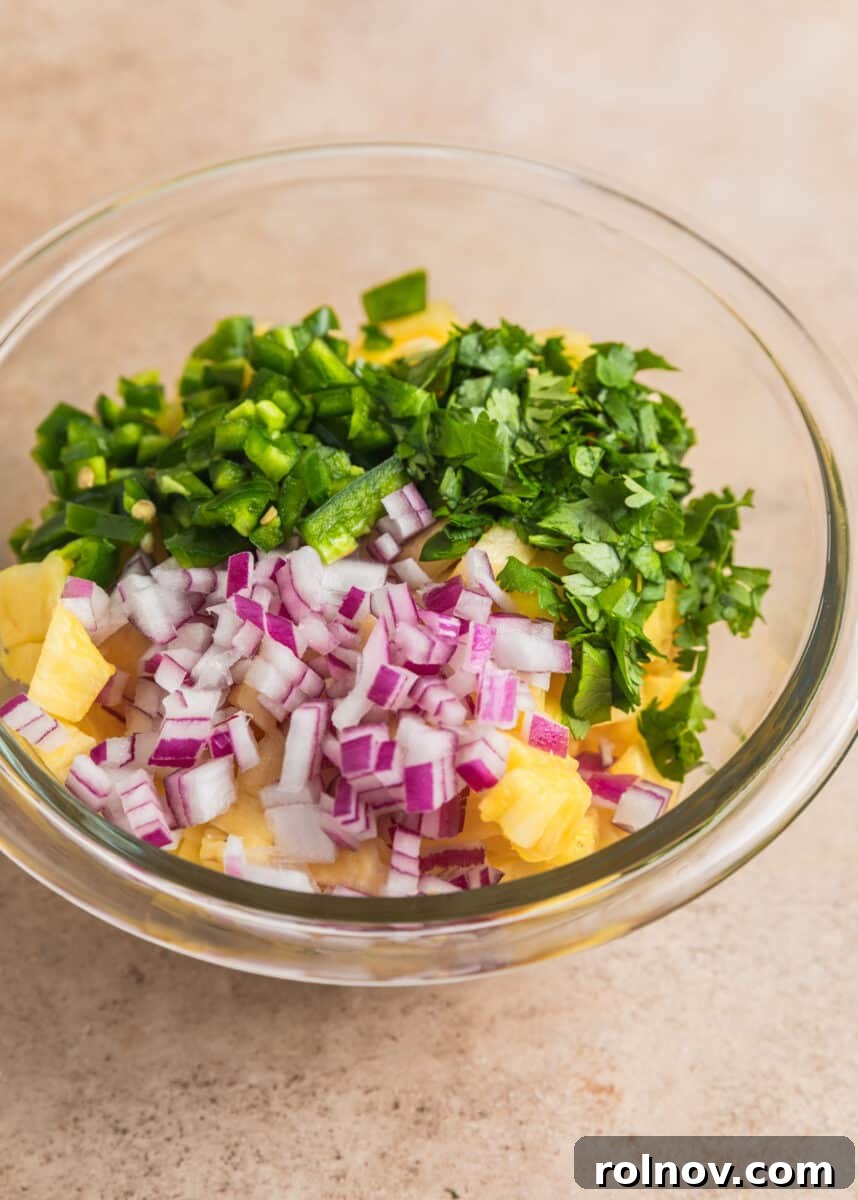 Zesty Pork Tacos with Fresh Pineapple Salsa 5 Diced pineapple, jalapeños, onion and cilantro in glass bowl.
