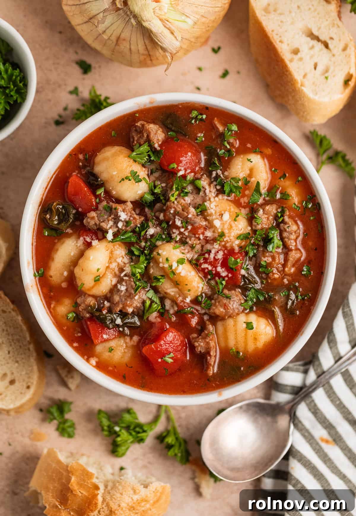 Hearty Sausage and Gnocchi Soup 2 Overhead view of 30 minute Italian sausage and gnocchi soup with parmesan on top.