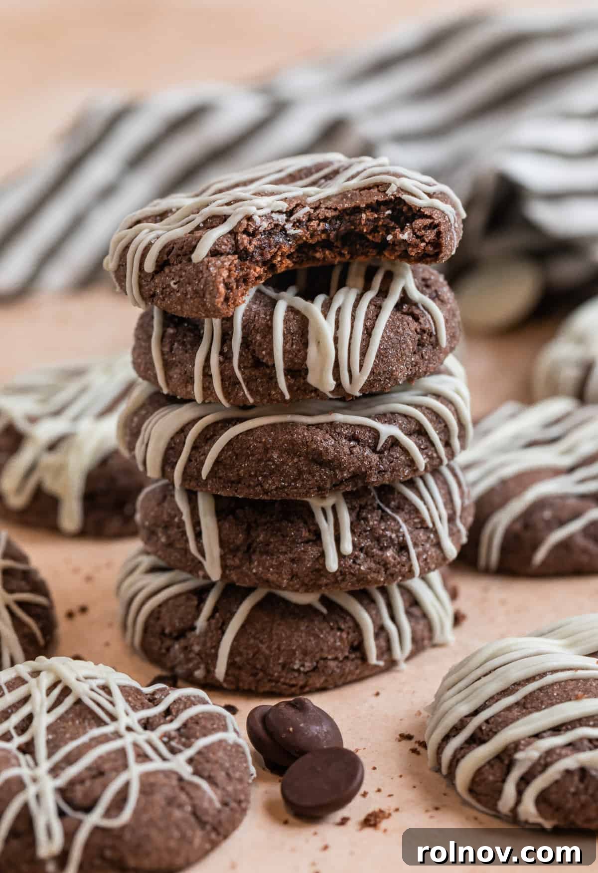 Effortless Chocolate Cake Mix Treats 3 A tempting stack of rich chocolate cake mix cookies, surrounded by loose chocolate chips and cookie crumbs, suggesting their deliciousness.