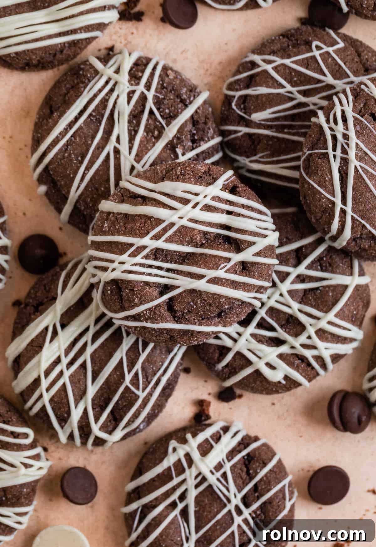Effortless Chocolate Cake Mix Treats 9 A close-up view of beautifully arranged chocolate cookies, rich in color, with scattered crumbs and chocolate chips for a rustic charm.