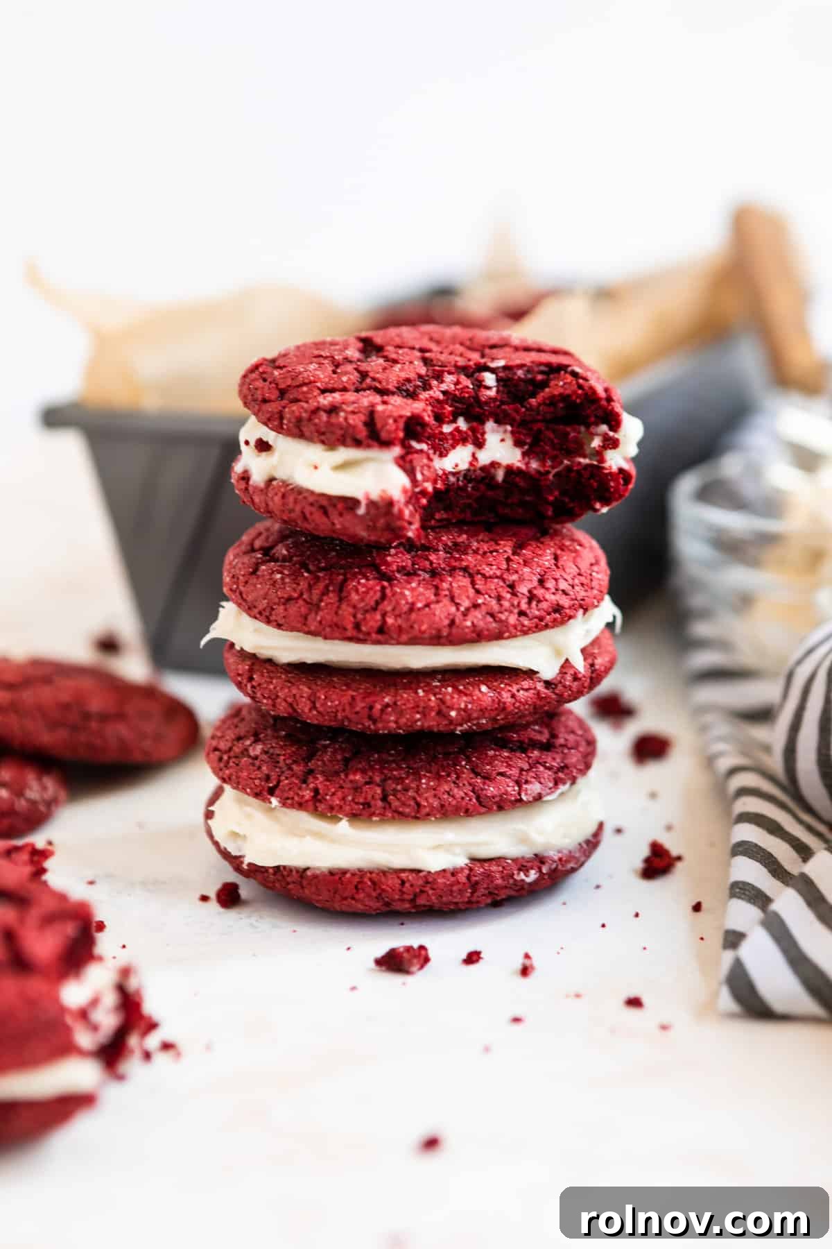 Scarlet Velvet Cake Mix Cookies with Tangy Cream Cheese Frosting 2 Stack of rich red velvet cake mix cookies with luscious cream cheese icing spilling from the center.