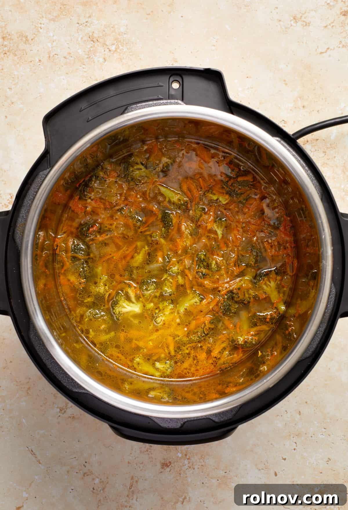 Creamy Instant Pot Broccoli Cheddar Soup 6 The cooked broccoli cheddar soup base inside the Instant Pot, just after pressure cooking and before the final additions of cream and cheese.