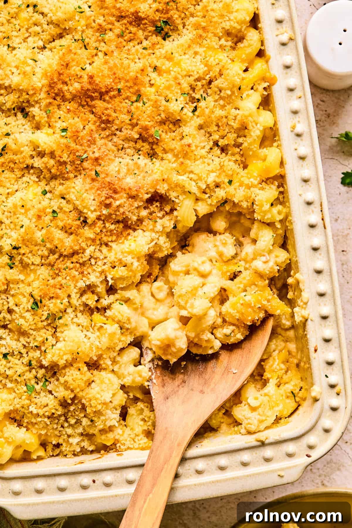 Gourmet Cheddar Gruyère Mac and Cheese 2 Cheddar gruyere macaroni and cheese in baking pan with spoon scooping into it.