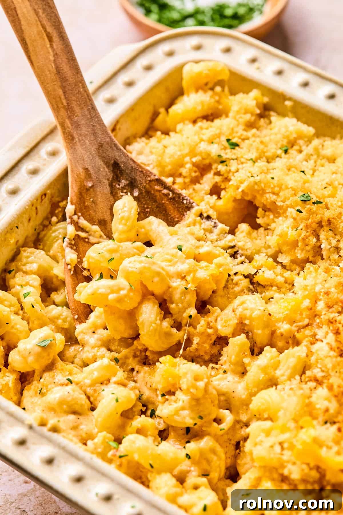 Gourmet Cheddar Gruyère Mac and Cheese 8 Pan of baked mac and cheese with serving spoon.