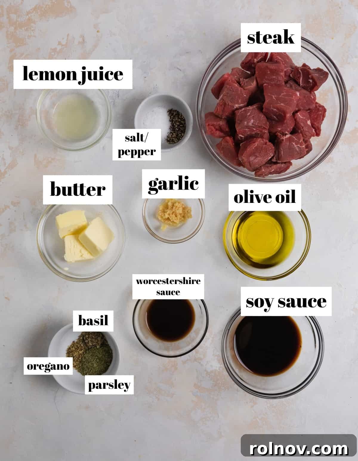Succulent Air Fryer Steak Bites 4 Olive oil, lemon juice, butter, herbs, and other ingredients labeled on counter.