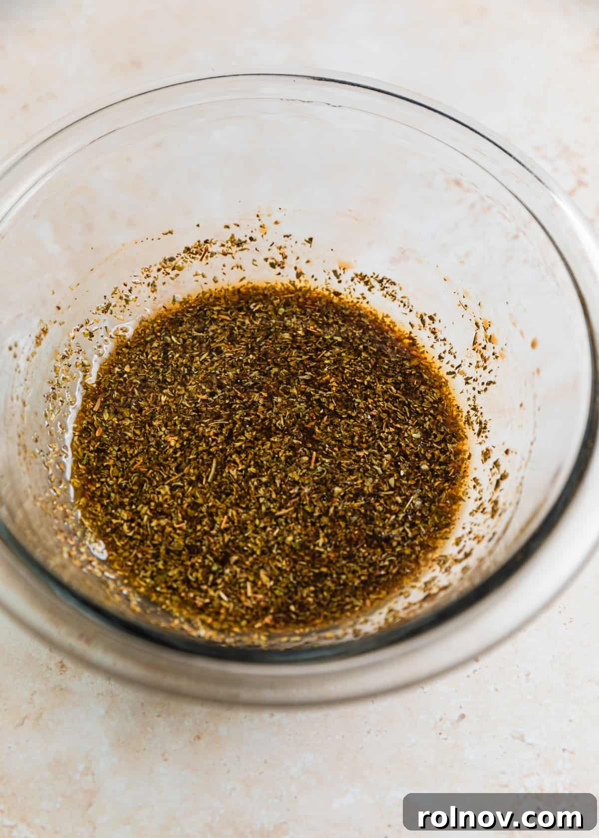 Succulent Air Fryer Steak Bites 5 Steak marinade in glass bowl with seasoning.