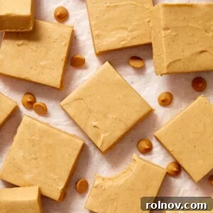 Microwave peanut butter fudge cut into squares and arranged on wax paper.