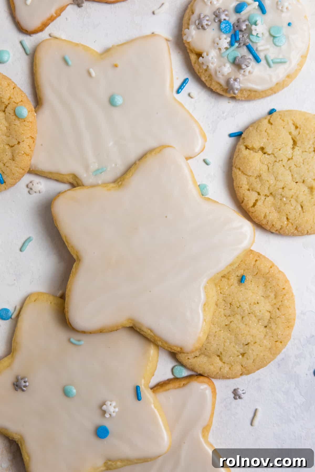 An overhead shot showcasing beautifully decorated star-shaped cut-out cookies, each adorned with white icing.