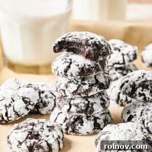 Stack of chocolate crinkle cookies with milk glass.