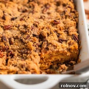 Casserole dish with baked brioche French toast casserole topped with pecan streusel.